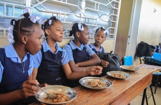 Girls in Haiti eating food together