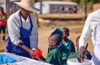 Child receiving Mary's Meals porridge