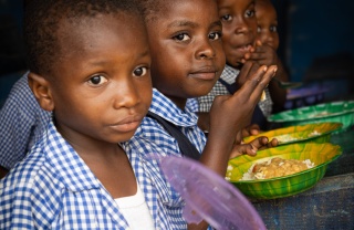 Children eating Mary's Meals' provided food