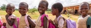 Children in Benin queuing for their school meal