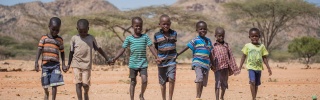 Children walking holding hands in Kenya