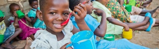 Child in Malawi eating porridge