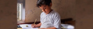 Boy in Yemen learning in class