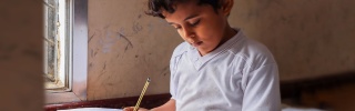 Boy in Yemen learning in class