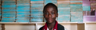 Samuel, 13, at school holding a book