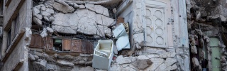 Kitchen cupboards visible within destroyed apartments from earthquake in Syria