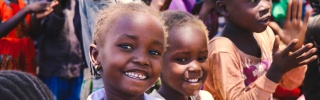 Children in Kenya smiling and clapping along