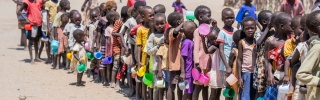Children line up to be served food in Kenya