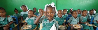 children eating food in Haiti