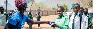 child receiving serving of Mary's Meals