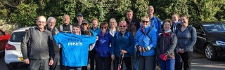 Mary's Meals supporters pose for picture with hiking gear and Mary's Meals t-shirts ahead of challenge