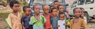 Children stand in front of the camera, outside, in Tigray, Ethiopia