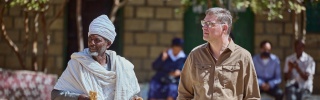 Mary's Meals Founder Magnus (right) in Ethiopia meeting a community member