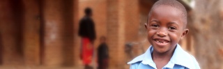 Image of child in Malawi holding their school meal