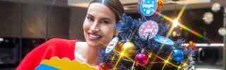 Ferne McCann with Mary's Meals sign next to Christmas Tree