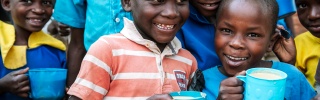 Children enjoying Mary's Meals at school in Malawi