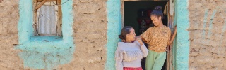 Lydia, right, and her mother, Shewit, left stand at an open doorway