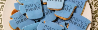 Biscuits shaped like mugs with Mary's Meals written on them
