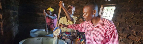 Volunteers gather around a stove to prepare food