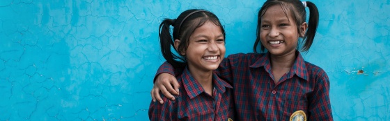 Twin sisters in India hugging