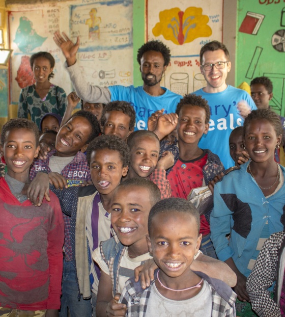 Children and volunteers gather in a classroom in Ethiopia