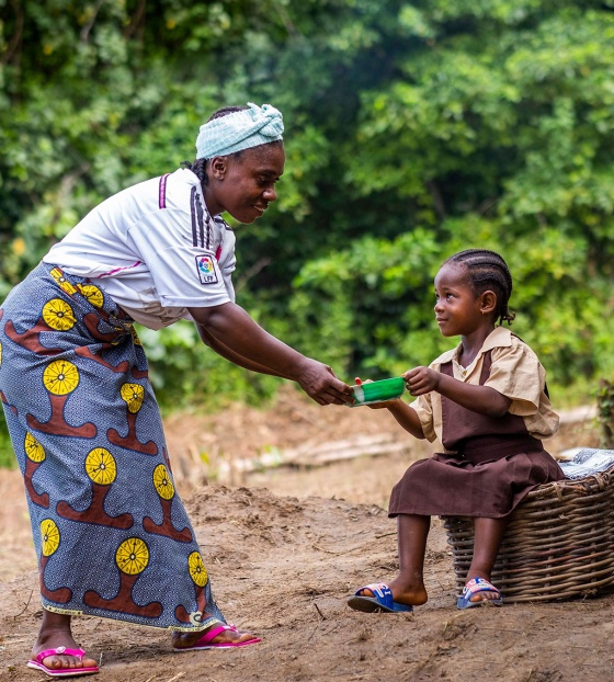 Cook in Liberia serving food