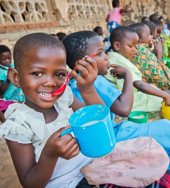 Child in Malawi eating porridge