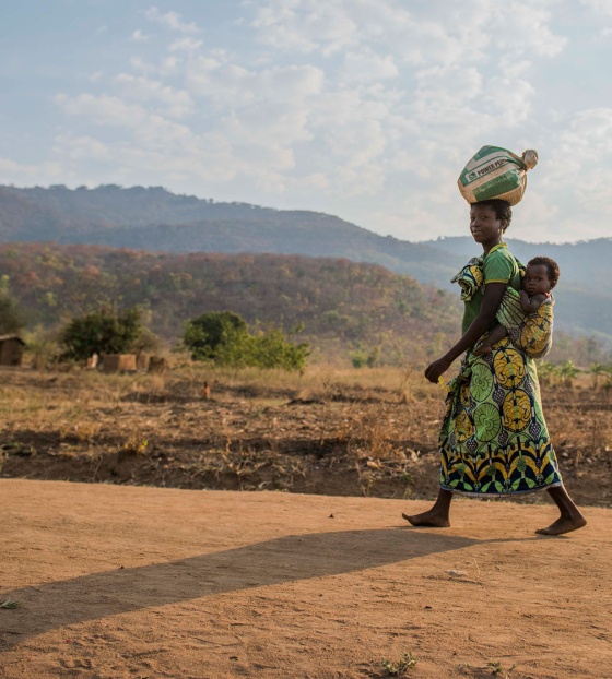 Woman carrying food bag to make Marys Meals