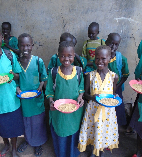 Smiling children with plates of Mary's Meals in South Sudan
