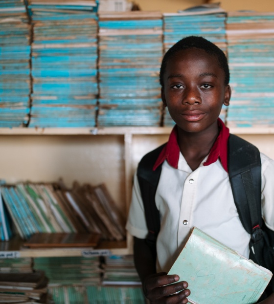 Samuel, 13, at school holding a book