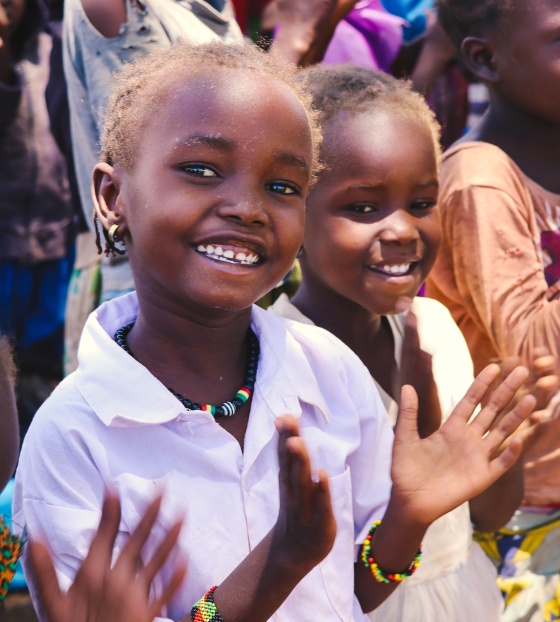 Children in Kenya smiling and clapping along