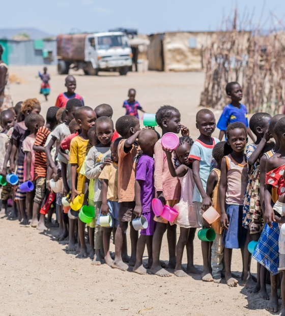 Children line up to be served food in Kenya