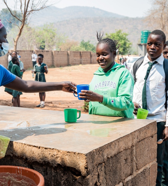 child receiving serving of Mary's Meals