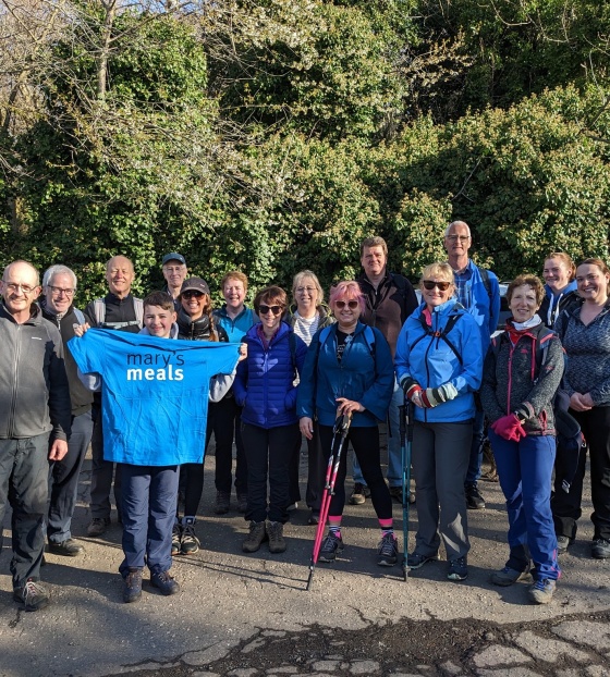 Mary's Meals supporters pose for picture with hiking gear and Mary's Meals t-shirts ahead of challenge