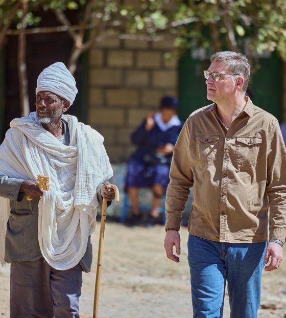 Mary's Meals Founder Magnus (right) in Ethiopia meeting a community member