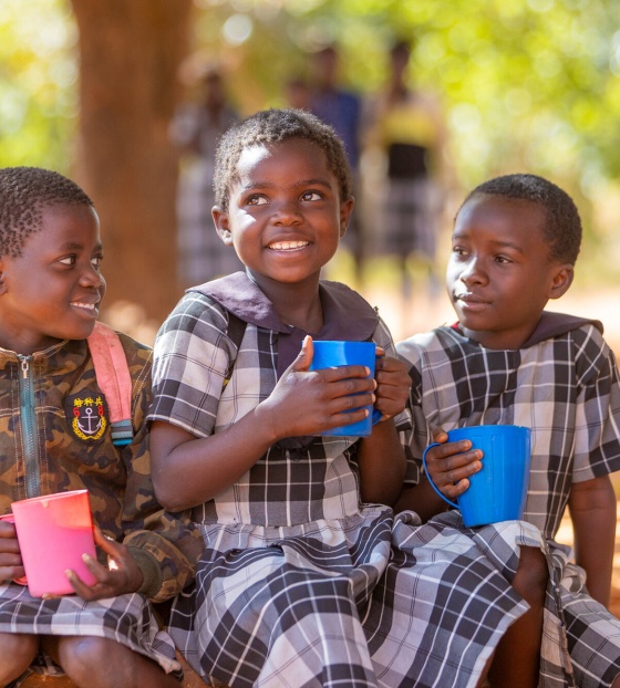 Image of three children eating thier school meals