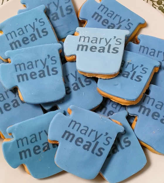 Biscuits shaped like mugs with Mary's Meals written on them