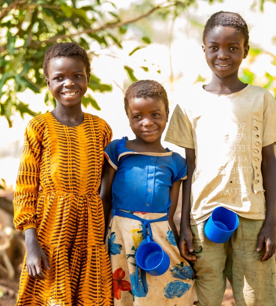 Three children standing with mugs