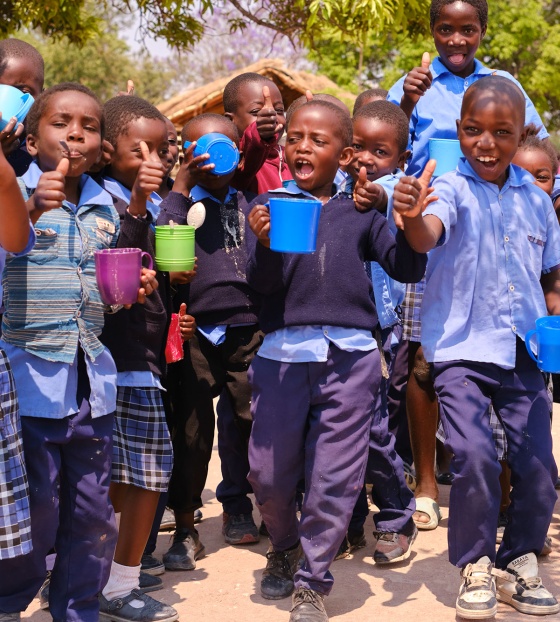 Image of children n Zambia happy with their school meals