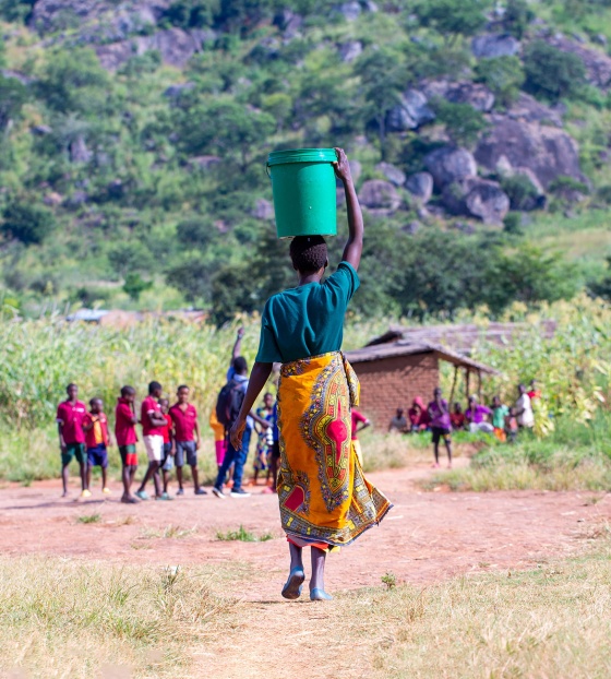 Image of women walking towards a school in Africa 