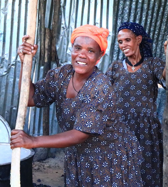 Volunteers in Ethiopia cooking food for children at school