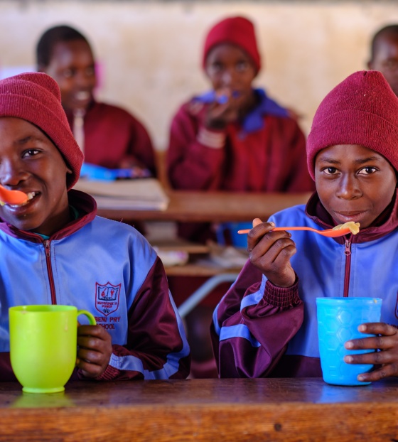 three boys eating Mary's Meals