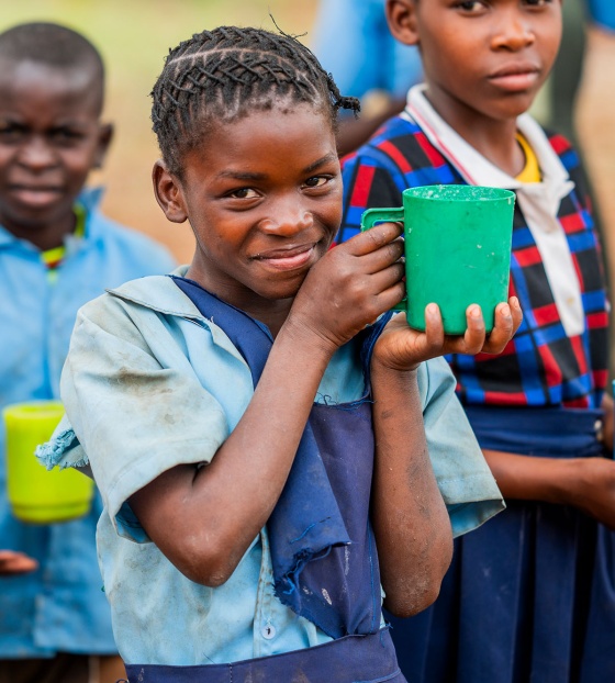 image of a child from Zambia holding their school meal