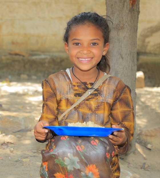 A child in Ethiopia holding their school meal