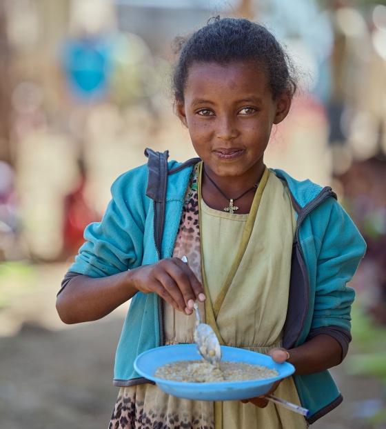 An image of a child in Ethiopia with their school meal