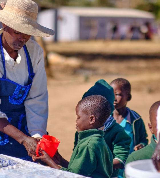 Child receiving Mary's Meals porridge