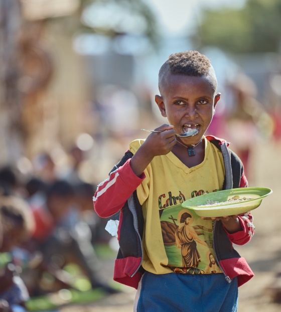 Boy eating porridge in Ethiopia