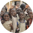 Children wave outside a school