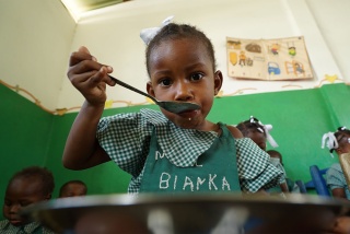 Girl in Haiti enjoying Marys Meals