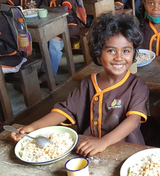 Child enjoying their school meal